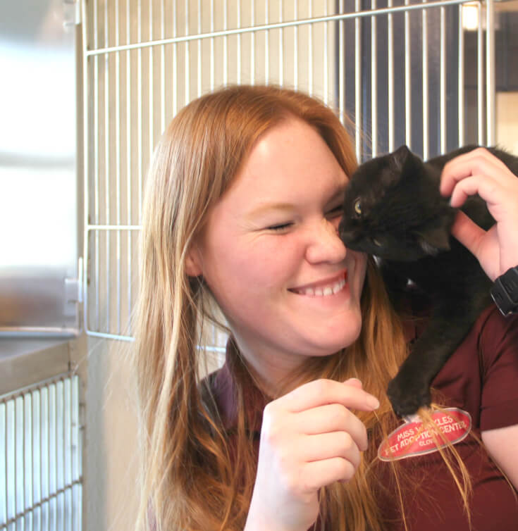 woman cuddling with cat at Miss Winkles