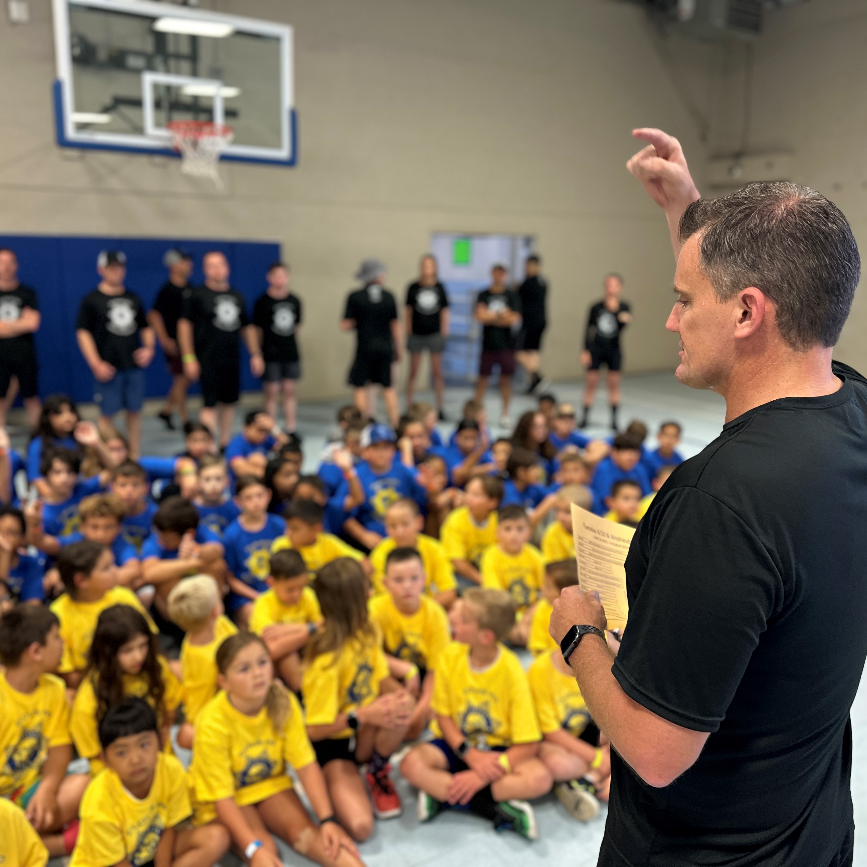 Officer teaching kids at Kids and Cops youth event